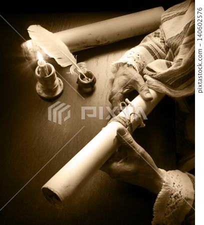 Man holding an old scroll Man holding an old scroll 140602576