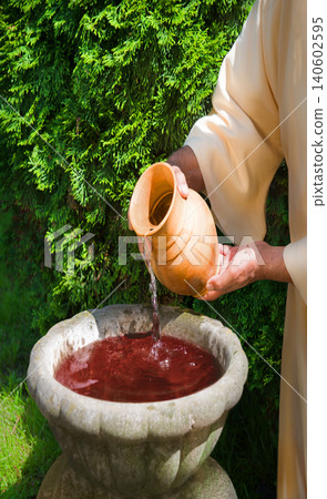 Hands pour water into the pot 140602595