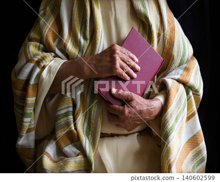 Old man holding a book 140602599