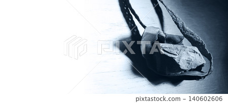 Sling with stone on wooden background Sling with stone on wooden background 140602606
