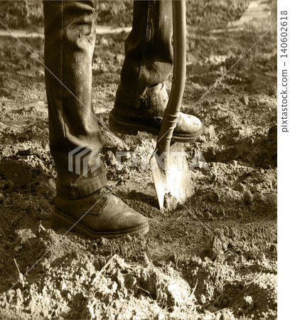 Man's feet with a shovel Man's feet with a shovel 140602618