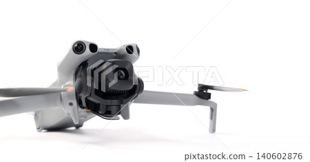 Drone camera. Modern camera drone with remote controller on white background. UAV or Unmanned Aerial Vehical technology for aerial photography videography mapping inspection and recreational flying. 140602876