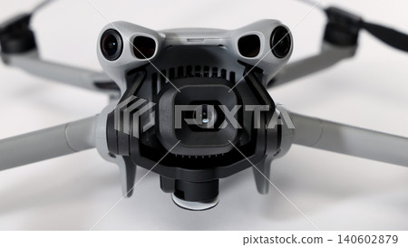 Drone camera. Modern camera drone with remote controller on white background. UAV or Unmanned Aerial Vehical technology for aerial photography videography mapping inspection and recreational flying. Drone camera. Modern camera drone with remote controller on white background. UAV or Unmanned Aerial Vehical technology for aerial photography videography mapping inspection and recreational flying. 140602879