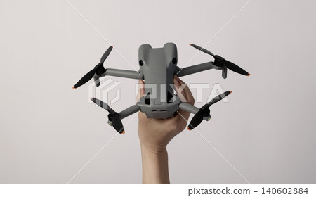 Drone camera. Modern camera drone with remote controller on white background. UAV or Unmanned Aerial Vehical technology for aerial photography videography mapping inspection and recreational flying. Drone camera. Modern camera drone with remote controller on white background. UAV or Unmanned Aerial Vehical technology for aerial photography videography mapping inspection and recreational flying. 140602884