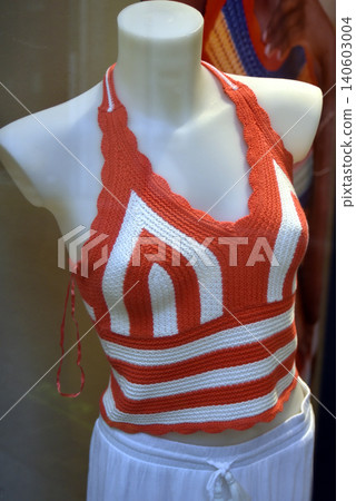 closeup of stripped orange top on mannequin in a fashion store showroom closeup of stripped orange top on mannequin in a fashion store showroom 140603004
