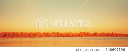 Autumn landscape with a lake. Branches with yellow leaves over the lake Autumn landscape with a lake. Branches with yellow leaves over the lake 140603196