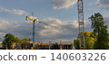 Construction site with cranes and building structures under a cloudy sky in the afternoon 140603226