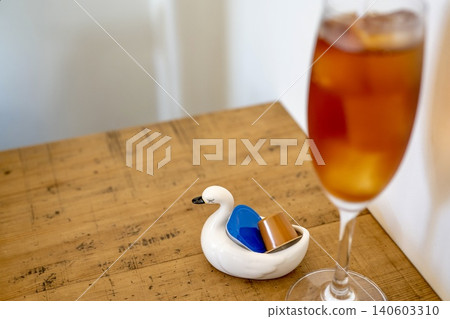 Iced tea and a cute crane figurine 140603310