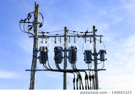 AC high-voltage power transformer, Electrical Transformer and High voltage power lines installed on electric pole. AC high-voltage power transformer, Electrical Transformer and High voltage power lines installed on electric pole. 140603325