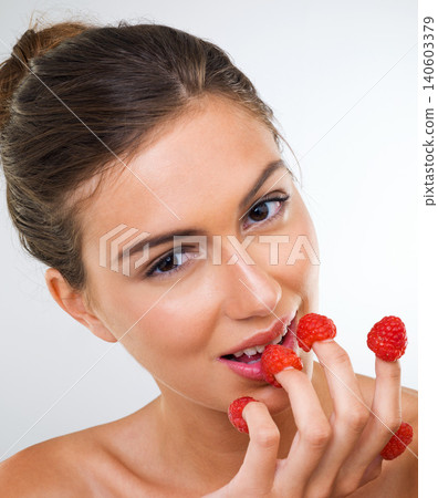 Woman, portrait and raspberry for health in studio for wellness detox, healthy eating and nutrition diet. Model, person and fruit for organic cosmetics, natural beauty or skincare on white background 140603379