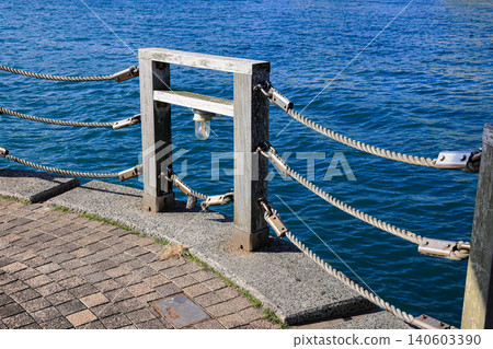 Steel turnbuckle and Wire Rope Assemble as railing. Steel Wire Rope Sling and metal cable clamp connected with screw bolt in sideway railing. 140603390
