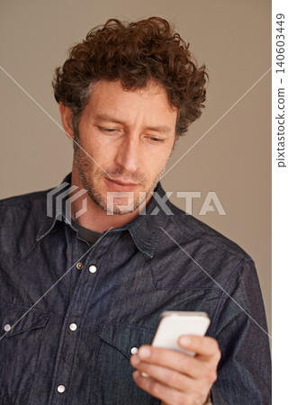 Mature man, phone and texting in studio for thinking, reading or scroll for search on web by background. Person, smartphone and check for email, notification or post on social network with mobile app Mature man, phone and texting in studio for thinking, reading or scroll for search on web by background. Person, smartphone and check for email, notification or post on social network with mobile app 140603449