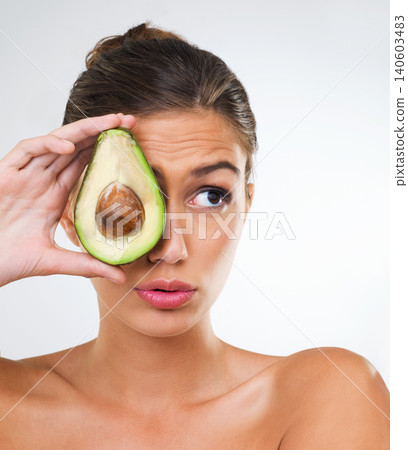 Woman, face and avocado for health in studio for wellness detox, healthy skin and hydration with omega 3. Model, person and fruit for organic cosmetics, natural beauty or skincare on white background Woman, face and avocado for health in studio for wellness detox, healthy skin and hydration with omega 3. Model, person and fruit for organic cosmetics, natural beauty or skincare on white background 140603483