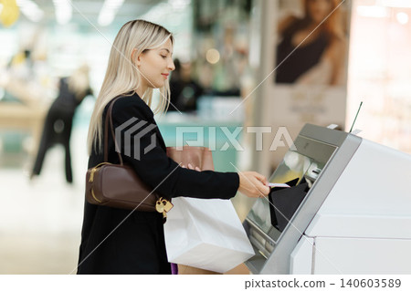 Woman using cash machine for financial transaction Woman using cash machine for financial transaction 140603589