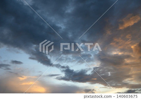 Evening cloudy skyline with sunset glow above urban horizon heavy clouds and bright city edge Evening cloudy skyline with sunset glow above urban horizon heavy clouds and bright city edge 140603675