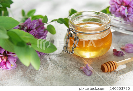Natural acacia honey in a jar with flowers 140603750