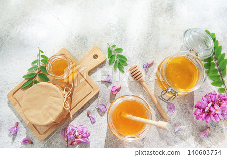 Sweet organic honey jars and acacia flowers Sweet organic honey jars and acacia flowers 140603754