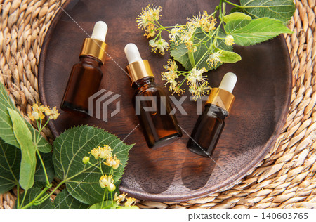 Linden essential oil dropper bottles for natural aromatherapy Linden essential oil dropper bottles for natural aromatherapy 140603765