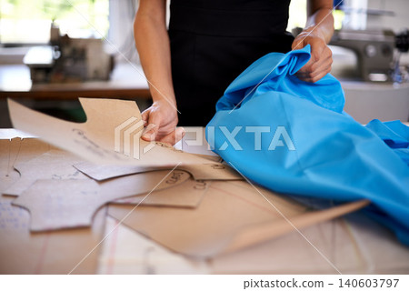 Fashion designer, patterns and fabric for clothes production, planning and measurements in workshop. Person hands with cardboard or shape of garment for manufacturing, design and textile business Fashion designer, patterns and fabric for clothes production, planning and measurements in workshop. Person hands with cardboard or shape of garment for manufacturing, design and textile business 140603797