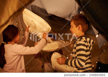 Children, pillow fight and siblings in a fort with funny, playing or bonding at home together. Family, love and kids in a living room tent with cushion, games or having fun on staycation in house Children, pillow fight and siblings in a fort with funny, playing or bonding at home together. Family, love and kids in a living room tent with cushion, games or having fun on staycation in house 140603802