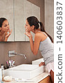 Bathroom, face in mirror and woman for skincare, beauty and wellness in morning routine. Health, dermatology and person in reflection for pimple, home or facial for cleaning, hygiene and grooming 140603837
