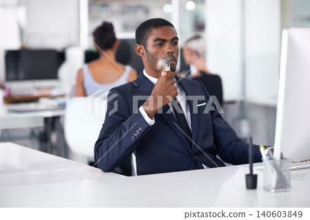 Black man, smoking and vaping in office or business with cigarette, electronic pipe in formal clothes. Businessman, corporate and working on computer, technology or connect and salesman in workplace Black man, smoking and vaping in office or business with cigarette, electronic pipe in formal clothes. Businessman, corporate and working on computer, technology or connect and salesman in workplace 140603849