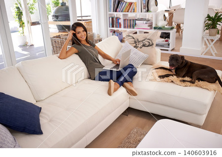 Woman, laptop and living room with dog on sofa, working or relaxing and smile in couch. Female person, watching or typing in computer, technology and connectivity for results in lounge or house Woman, laptop and living room with dog on sofa, working or relaxing and smile in couch. Female person, watching or typing in computer, technology and connectivity for results in lounge or house 140603916