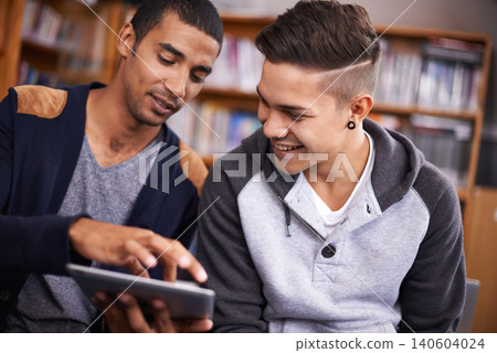 Tablet, students or talking of project in library or diversity for academic knowledge in university. Young men, technology or collaboration for assignment or online research for education in college Tablet, students or talking of project in library or diversity for academic knowledge in university. Young men, technology or collaboration for assignment or online research for education in college 140604024