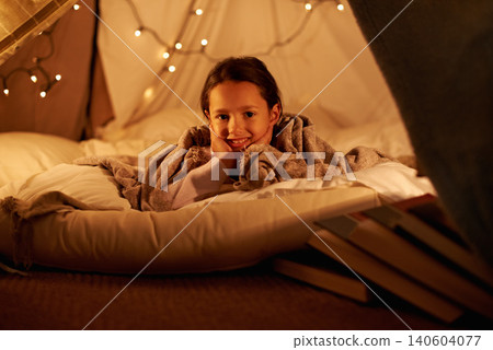 Portrait, happy and girl in a bedroom fort in a house for holiday, games or staycation fun. Face, smile and happy kid in a diy tent for playing, resting or enjoy weekend with camping fantasy in house 140604077