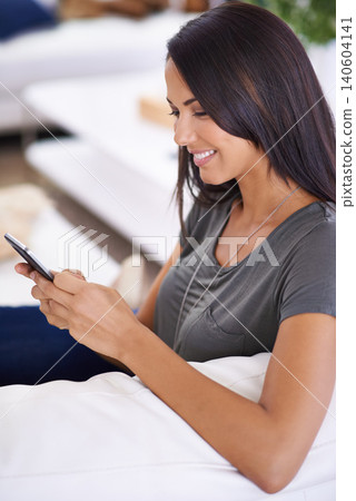 Woman, couch and phone for browse on social media in home, comfortable and website for entertainment. Female person, smile and app for blog and subscription, living room and relax on sofa for texting 140604141