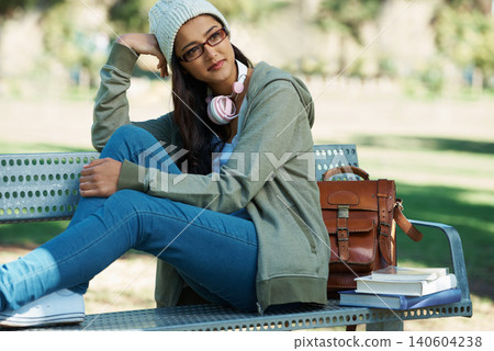 Thinking, relax and student in park with books for studying, learning and reading outdoors. Education, happy and person with bag, textbooks and headphones on bench for university, campus or college Thinking, relax and student in park with books for studying, learning and reading outdoors. Education, happy and person with bag, textbooks and headphones on bench for university, campus or college 140604238
