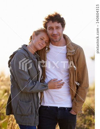 Couple, hug in nature and portrait in park, love and support with date for bonding and time together. Sunset, calm and people in forest for fresh air, loyalty and commitment with peace outdoor 140604315