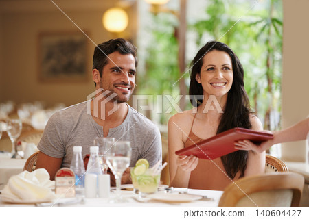 Couple, restaurant and menu with dinner, romance and love for anniversary or celebration. Woman, man and date with luxury, fine dining and smile for relationship on holiday or vacation with meal Couple, restaurant and menu with dinner, romance and love for anniversary or celebration. Woman, man and date with luxury, fine dining and smile for relationship on holiday or vacation with meal 140604427