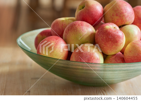 Fruit, kitchen and red apples in bowl on table for nutrition, diet and food for lunch in house. Natural, summer and healthy for eating in morning, breakfast and fresh with Vitamin C for vegan Fruit, kitchen and red apples in bowl on table for nutrition, diet and food for lunch in house. Natural, summer and healthy for eating in morning, breakfast and fresh with Vitamin C for vegan 140604455