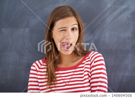 Tongue out, blackboard and portrait with woman, teacher and education with knowledge and silly. Face, funny and goofy with girl or educator with expression or emoji with reaction or quirky with humor Tongue out, blackboard and portrait with woman, teacher and education with knowledge and silly. Face, funny and goofy with girl or educator with expression or emoji with reaction or quirky with humor 140604508