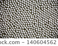A photograph of a background image covered with small white ceramic balls. 140604562