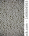 A photograph of a background image covered with small white ceramic balls. 140604563