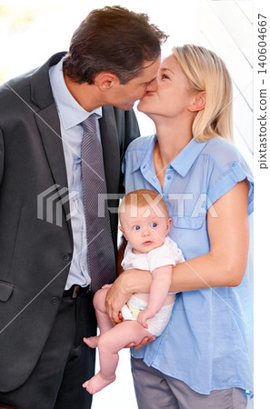 Love, family and parents kiss with baby, bonding or affection at home on valentines day. Child, toddler or mother with father in romance for connection, care or healthy relationship together in house 140604667