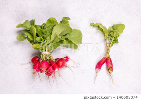 Fresh organic radishes with green leaves on light background Fresh organic radishes with green leaves on light background 140605074