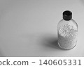Product image of small white ceramic balls in a glass container used for scientific and chemical experiments. 140605331