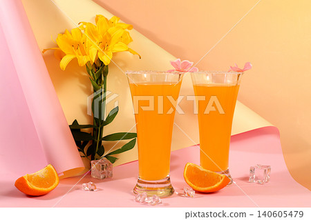 Orange juice, cocktail and ice cubes on sunny elegant background, modern still life with lilies, summer party concept, minimalist abstract background for alcoholic drinks presentation, design template Orange juice, cocktail and ice cubes on sunny elegant background, modern still life with lilies, summer party concept, minimalist abstract background for alcoholic drinks presentation, design template 140605479