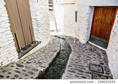 Pampaneira, in the Alpujarra region of Granada, with its narrow, steep streets and water channels running through them Pampaneira, in the Alpujarra region of Granada, with its narrow, steep streets and water channels running through them 140605694