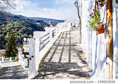 Pampaneira, in the Alpujarra region of Granada, with its narrow, steep streets and water channels running through them Pampaneira, in the Alpujarra region of Granada, with its narrow, steep streets and water channels running through them 140605698