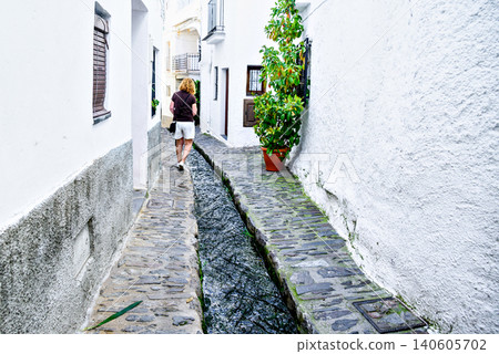 Pampaneira, in the Alpujarra region of Granada, with its narrow, steep streets and water channels running through them Pampaneira, in the Alpujarra region of Granada, with its narrow, steep streets and water channels running through them 140605702