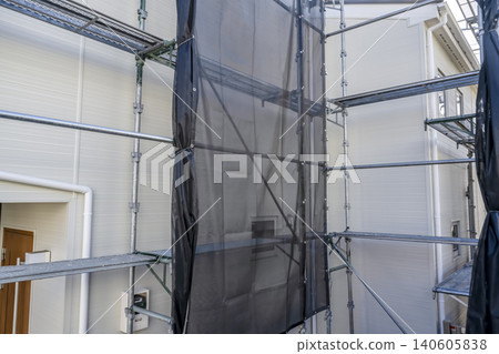 After exterior wall renovation of a detached house: New siding and scaffolding After exterior wall renovation of a detached house: New siding and scaffolding 140605838