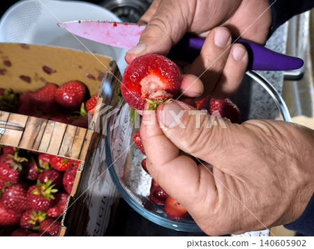 Close-up of male hands cleaning ripe strawberries. Close-up of male hands cleaning ripe strawberries. 140605902