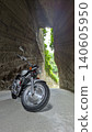 Motorcycle emerging from tunnel 140605950