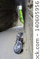 Motorcycle emerging from tunnel 140605956