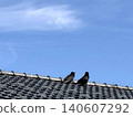 crow perched on the roof 140607292