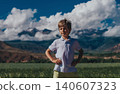 Portrait of boy on mountains background in summer 140607323
